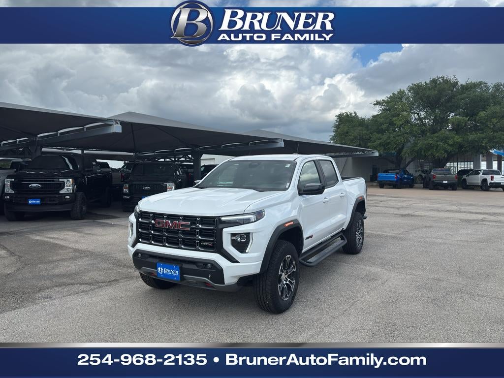 2025 GMC Canyon AT4 in Summit White — front three-quarter view