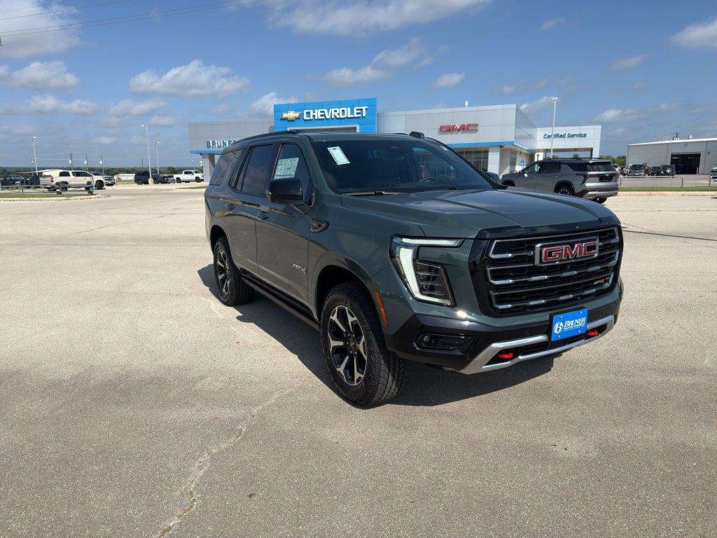2026 GMC Yukon AT4 in Midnight Pine — front three-quarter view