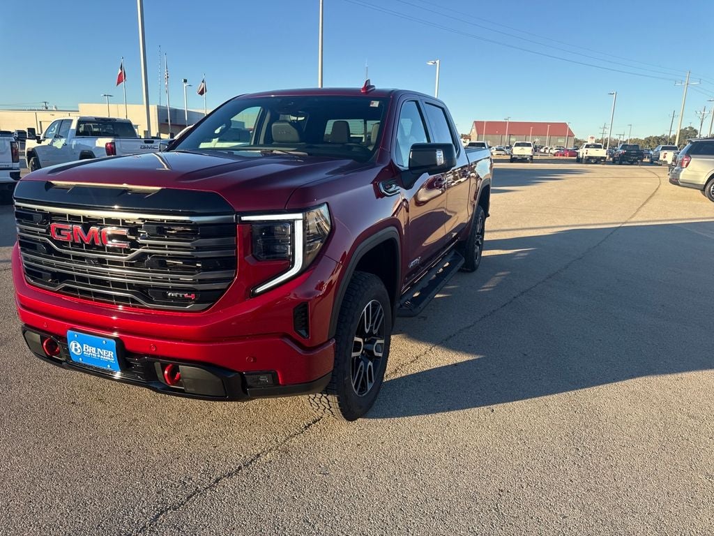 2026 GMC Sierra 1500 AT4 in Volcanic Red Tintcoat — front three-quarter view