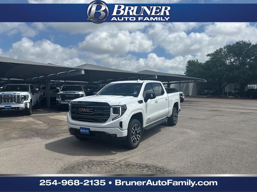 2025 GMC Sierra 1500 4WD Crew Cab Short Box AT4 in Summit White — front three-quarter view